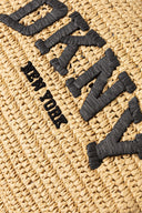 Woven raffia DKNY tote in natural beige with black details and bold logo, spacious and structured with dual handles and shoulder strap — ψάθινη DKNY τσάντα σε φυσική απόχρωση με μαύρες λεπτομέρειες και λογότυπο, ευρύχωρη και κομψή, ιδανική για summer city looks και resort styling με minimal χαρακτήρα. Διαθέσιμη στο Iconic Angels Glyfada.