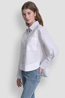 White long-sleeve button-down shirt with classic collar, front pocket and clean structured silhouette, offering timeless minimal elegance for versatile styling — λευκό γυναικείο πουκάμισο με κουμπιά, γιακά και μπροστινή τσέπη, ιδανικό για office chic και smart casual looks με refined χαρακτήρα. Διαθέσιμο στο Iconic Angels Glyfada.