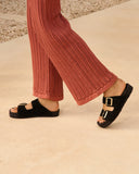 Suede Nordic sandals in classic black with satin gold buckles and a natural jute footbed, combining timeless elegance with everyday comfort — μαύρα suede Nordic σανδάλια με σατινέ χρυσές αγκράφες και φυσικό πάτο από σχοινί, ιδανικά για effortless chic εμφανίσεις που φοριούνται από το πρωί έως το βράδυ. Διαθέσιμα στο Iconic Angels Glyfada.