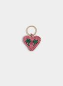 Handwoven heart keychain in raffia with playful character and summery feel, the perfect little accessory to elevate your everyday essentials — πλεκτό μπρελόκ καρδιά από raffia με παιχνιδιάρικο design και καλοκαιρινή διάθεση, ιδανικό για να δώσει χαρακτήρα στα κλειδιά ή την τσάντα σας. Διαθέσιμο στο Iconic Angels Glyfada.