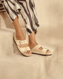 Women’s suede slide sandals in off-white with double buckle straps and espadrille sole, γυναικεία σανδάλια slides από suede δέρμα σε εκρού απόχρωση με διπλή αγκράφα και σχοινένια σόλα, κομψά και άνετα για καλοκαιρινές εμφανίσεις, από το Iconic Angels Glyfada.