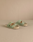 Suede Nordic sandals in soft sage green with adjustable buckles and a natural jute footbed, bringing a fresh, laid-back feel to everyday summer styling — σουέτ Nordic σανδάλια σε απαλό sage green με ρυθμιζόμενες αγκράφες και φυσικό πάτο από σχοινί, ιδανικά για δροσερά και effortless καλοκαιρινά looks από το πρωί έως το βράδυ. Διαθέσιμα στο Iconic Angels Glyfada.
