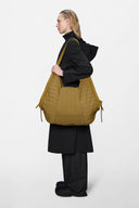 Quilted khaki shoulder bag with sculptural silhouette, ultra-light and statement-making, designed for effortless day-to-night styling — καπιτονέ χακί shoulder bag με ιδιαίτερη γραμμή, ανάλαφρη αλλά εντυπωσιακή, ιδανική για μοντέρνα looks από το πρωί έως το βράδυ. Διαθέσιμη στο Iconic Angels Glyfada.