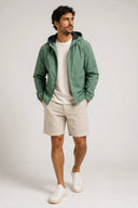 Lightweight green hooded jacket with clean lines and water-resistant finish — ανάλαφρο πράσινο jacket με κουκούλα, minimal αισθητική και αδιάβροχη υφή για προστασία με urban χαρακτήρα. Ιδανικό για layering και effortless street looks, από το πρωινό commute μέχρι τις βραδινές εξόδους. Διαθέσιμο στο Iconic Angels Glyfada.
