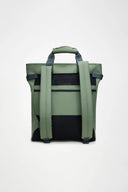 Waterproof green backpack with bold RAINS logo, structured design and practical front pockets for everyday essentials — αδιάβροχο πράσινο backpack με statement λογότυπο RAINS, minimal αισθητική και λειτουργικές μπροστινές θήκες για άνετη οργάνωση στην πόλη ή στις αποδράσεις του weekend. Διαθέσιμο στο Iconic Angels Glyfada.