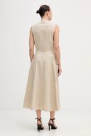 Beige sleeveless midi dress with clean round neckline, fitted waist and flared skirt with side pockets, combining minimal elegance with effortless structure — μπεζ αμάνικο midi φόρεμα με καθαρή λαιμόκοψη, τονισμένη μέση και άνετη φούστα με τσέπες, ιδανικό για office chic και refined day looks. Διαθέσιμο στο Iconic Angels Glyfada.