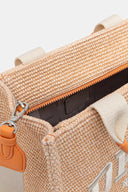 DKNY Hadlee Medium Tote σε φυσική ψάθινη υφή με λευκό λογότυπο “DKNY New York”, πορτοκαλί λεπτομέρειες και αποσπώμενο ρυθμιζόμενο λουρί ώμου. Μεσαία καλοκαιρινή tote τσάντα ιδανική για city looks και resort εμφανίσεις. Διαθέσιμη στο Iconic Angels.