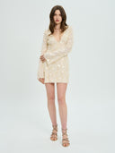 Project Soma cream mini dress with textured fringe and sequin detailing, featuring a deep V-neckline, long sleeves and fitted silhouette for statement evening and party looks — γυναικείο Project Soma κρεμ mini φόρεμα με κρόσσια και παγιέτες, βαθύ ντεκολτέ και μακριά μανίκια, ιδανικό για εντυπωσιακές βραδινές εμφανίσεις.