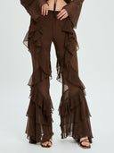 Project Soma brown sheer ruffle pants with layered chiffon detailing and flowing wide-leg silhouette, featuring a high-waisted fit and statement cascading frills for bold evening and fashion-forward looks — γυναικείο Project Soma καφέ διάφανο παντελόνι με βολάν και layered chiffon υφή, σε εντυπωσιακή wide-leg γραμμή για ιδιαίτερα βραδινά looks.