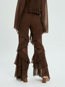 Project Soma brown sheer ruffle pants with layered chiffon detailing and flowing wide-leg silhouette, featuring a high-waisted fit and statement cascading frills for bold evening and fashion-forward looks — γυναικείο Project Soma καφέ διάφανο παντελόνι με βολάν και layered chiffon υφή, σε εντυπωσιακή wide-leg γραμμή για ιδιαίτερα βραδινά looks.