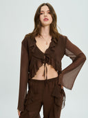 Project Soma brown sheer ruffle crop top with lightweight chiffon fabric and cascading frill detailing, featuring a deep V neckline, tie-front closure and flared sleeves for bold coordinated and evening looks — γυναικείο Project Soma καφέ διάφανο crop top με βολάν και chiffon υφή, με βαθύ ντεκολτέ, δέσιμο μπροστά και καμπάνα μανίκια για εντυπωσιακά σύνολα.