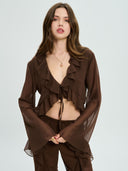 Project Soma brown sheer ruffle crop top with lightweight chiffon fabric and cascading frill detailing, featuring a deep V neckline, tie-front closure and flared sleeves for bold coordinated and evening looks — γυναικείο Project Soma καφέ διάφανο crop top με βολάν και chiffon υφή, με βαθύ ντεκολτέ, δέσιμο μπροστά και καμπάνα μανίκια για εντυπωσιακά σύνολα.