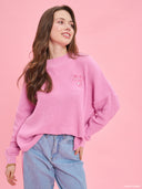 Pink oversized knit sweater from Project Soma x Barbie collection with embroidered Barbie logo and relaxed silhouette for cozy stylish looks — ροζ πλεκτό oversized γυναικείο πουλόβερ Project Soma x Barbie με κεντημένο Barbie logo και άνετη γραμμή για μοντέρνα casual looks. Διαθέσιμο στο Iconic Angels Glyfada.