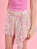 Pink floral ruffle skort from Project Soma x Barbie collection with asymmetric draped detail and playful silhouette for statement summer styling — ροζ floral γυναικείο skort Project Soma x Barbie με ασύμμετρο ruffle και ανάλαφρη γραμμή για εντυπωσιακά summer looks. Διαθέσιμο στο Iconic Angels Glyfada.