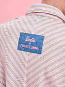 Striped oversized shirt from Project Soma x Barbie collection with pastel stripes and embroidered logo for playful contemporary styling — γυναικείο ριγέ oversized πουκάμισο από τη συλλογή Project Soma x Barbie με pastel ρίγες και κεντημένο logo για μοντέρνα playful looks. Διαθέσιμο στο Iconic Angels Glyfada.
