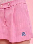 Pink pinstripe tailored shorts from Project Soma x Barbie collection with embroidered logo and structured silhouette for playful chic styling — ροζ ριγέ γυναικείο σορτς Project Soma x Barbie με κεντημένο logo και tailored γραμμή για μοντέρνα summer looks. Διαθέσιμο στο Iconic Angels Glyfada.