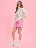 Pink pinstripe tailored shorts from Project Soma x Barbie collection with embroidered logo and structured silhouette for playful chic styling — ροζ ριγέ γυναικείο σορτς Project Soma x Barbie με κεντημένο logo και tailored γραμμή για μοντέρνα summer looks. Διαθέσιμο στο Iconic Angels Glyfada.