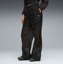 Black lightweight wide leg pants with semi-sheer fabric and elastic waistband, featuring subtle Puma logo detail for a modern sporty look — μαύρο γυναικείο παντελόνι σε wide leg γραμμή με ελαστική μέση και ελαφριά διαφάνεια, ιδανικό για athleisure, layering και chic sporty everyday looks. Διαθέσιμο στο Iconic Angels Glyfada.
