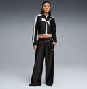 Black cropped track jacket with contrast white side stripes and bold Puma logo detail, combining retro sport heritage with modern streetwear appeal — μαύρο γυναικείο cropped track jacket με λευκές ρίγες στα μανίκια και statement logo μπροστά, ιδανικό για athleisure και street style looks με δυναμικό χαρακτήρα. Διαθέσιμο στο Iconic Angels Glyfada.