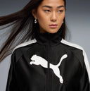 Black cropped track jacket with contrast white side stripes and bold Puma logo detail, combining retro sport heritage with modern streetwear appeal — μαύρο γυναικείο cropped track jacket με λευκές ρίγες στα μανίκια και statement logo μπροστά, ιδανικό για athleisure και street style looks με δυναμικό χαρακτήρα. Διαθέσιμο στο Iconic Angels Glyfada.
