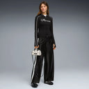 Black wide leg track pants with contrast white side stripes and bold Puma logo detail on the back, combining retro sport heritage with modern streetwear appeal — μαύρο γυναικείο παντελόνι φόρμας σε wide leg γραμμή με λευκές ρίγες στο πλάι και statement logo πίσω, ιδανικό για athleisure και street style looks. Διαθέσιμο στο Iconic Angels Glyfada.