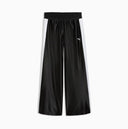 Black wide leg track pants with contrast white side stripes and bold Puma logo detail on the back, combining retro sport heritage with modern streetwear appeal — μαύρο γυναικείο παντελόνι φόρμας σε wide leg γραμμή με λευκές ρίγες στο πλάι και statement logo πίσω, ιδανικό για athleisure και street style looks. Διαθέσιμο στο Iconic Angels Glyfada.