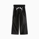 Black wide leg track pants with contrast white side stripes and bold Puma logo detail on the back, combining retro sport heritage with modern streetwear appeal — μαύρο γυναικείο παντελόνι φόρμας σε wide leg γραμμή με λευκές ρίγες στο πλάι και statement logo πίσω, ιδανικό για athleisure και street style looks. Διαθέσιμο στο Iconic Angels Glyfada.