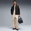 Black zip-up track jacket with contrast white side stripes and subtle Puma logo detail, combining retro sport heritage with modern street style appeal — μαύρο ανδρικό track jacket με φερμουάρ και λευκές ρίγες στα μανίκια, ιδανικό για athleisure, street style και casual everyday looks με sporty χαρακτήρα. Διαθέσιμο στο Iconic Angels Glyfada.