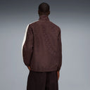 Chocolate brown zip-up track jacket with contrast side stripes and subtle Puma logo detail, combining retro sport heritage with modern street aesthetics — καφέ ανδρικό track jacket με φερμουάρ και λευκές ρίγες στα μανίκια, ιδανικό για athleisure, street style και casual everyday looks με premium χαρακτήρα. Διαθέσιμο στο Iconic Angels Glyfada.