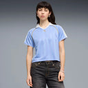 Light blue short sleeve polo top with contrast collar and subtle Puma logo detail, blending retro sport aesthetics with modern relaxed fit — γαλάζιο κοντομάνικο polo t-shirt με γιακά και sporty γραμμές, ιδανικό για casual, athleisure και 90s inspired everyday looks. Διαθέσιμο στο Iconic Angels Glyfada.