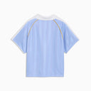 Light blue short sleeve polo top with contrast collar and subtle Puma logo detail, blending retro sport aesthetics with modern relaxed fit — γαλάζιο κοντομάνικο polo t-shirt με γιακά και sporty γραμμές, ιδανικό για casual, athleisure και 90s inspired everyday looks. Διαθέσιμο στο Iconic Angels Glyfada.