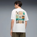 White graphic t-shirt with front logo detail and bold multicolor Puma artwork on the back, combining relaxed fit comfort with modern streetwear aesthetics — λευκό ανδρικό t-shirt με logo print μπροστά και statement πολύχρωμο graphic στην πλάτη, ιδανικό για street style και casual summer looks με urban χαρακτήρα. Διαθέσιμο στο Iconic Angels Glyfada.